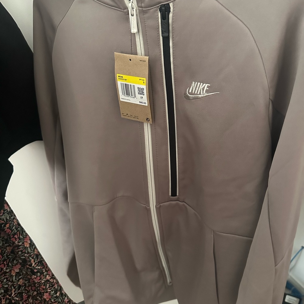 Brand new with tags . Nike zip up! Perfect color to match with anything. I love